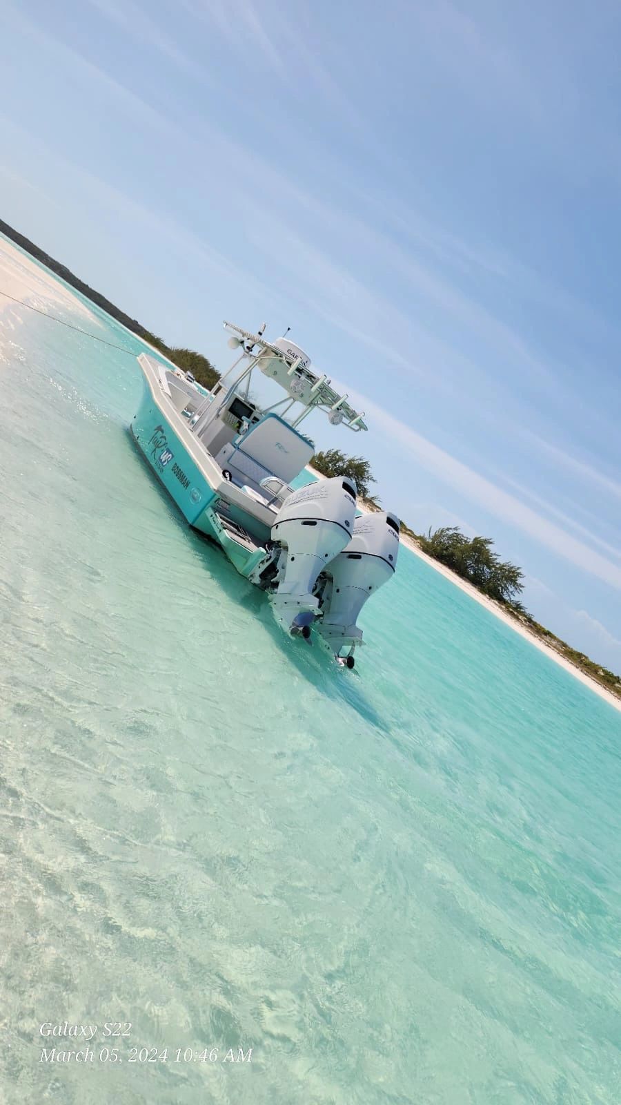 Aerial view of fishing boat in tropical water with Suzuki motors