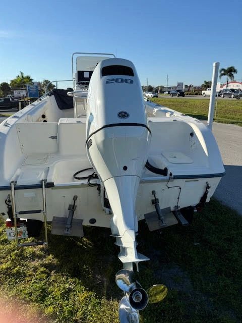 White fishing boat rear view with Suzuki outboard