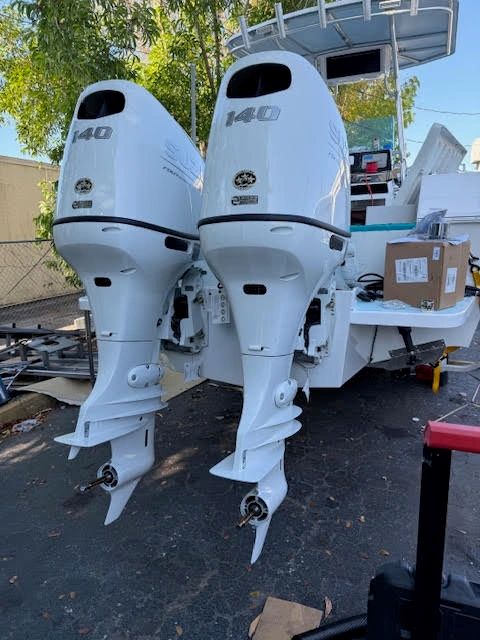 Twin Suzuki 140 outboard motors on trailer