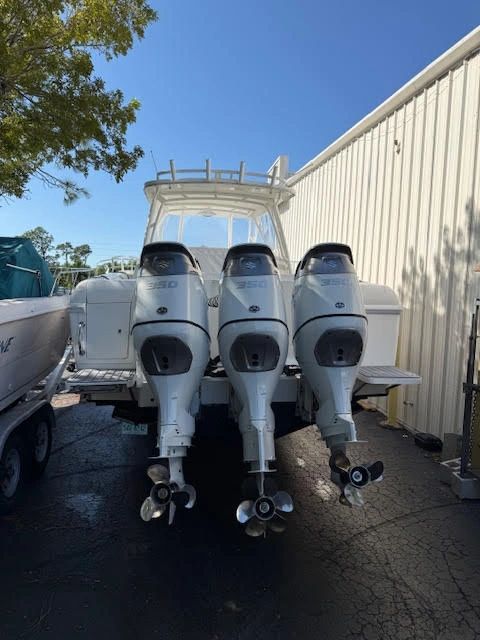 White center console with three Suzuki 350 outboard motors
