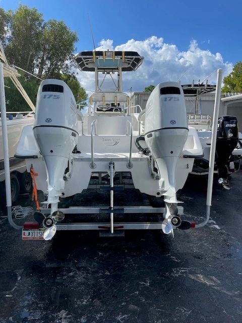 White center console fishing boat with twin 175 outboards